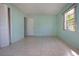 Empty bedroom with light teal walls and tile floors at 2413 Aspinwall St # 2413, Sarasota, FL 34237