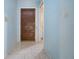 Light-blue walls and tiled floors in home entryway at 2413 Aspinwall St # 2413, Sarasota, FL 34237