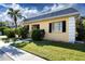 Front view of charming yellow house with manicured lawn at 2413 Aspinwall St # 2413, Sarasota, FL 34237