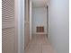 Hallway with tile floors and louvered doors at 2413 Aspinwall St # 2413, Sarasota, FL 34237