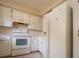 White kitchen appliances and cabinets. Needs updating at 2413 Aspinwall St # 2413, Sarasota, FL 34237