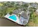 Aerial view of community pool, clubhouse, and surrounding landscape at 25 Tidy Island Blvd # 25, Bradenton, FL 34210