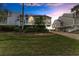 Evening view of waterfront home with landscaping at 25 Tidy Island Blvd, Bradenton, FL 34210