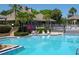 Refreshing community pool with lounge chairs and clubhouse in background at 25 Tidy Island Blvd # 25, Bradenton, FL 34210