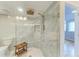 Large walk-in shower with marble tile and a rain shower head at 25 Tidy Island Blvd # 25, Bradenton, FL 34210