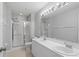 Bathroom with double sinks and a walk-in shower at 2608 Edgewater Ct, Palmetto, FL 34221