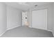 Spacious bedroom with grey carpet and double door closet at 2608 Edgewater Ct, Palmetto, FL 34221