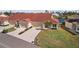 View of two-story home with red tile roof, two-car garage, and landscaped lawn at 2608 Edgewater Ct, Palmetto, FL 34221