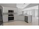 Modern kitchen with stainless steel appliances and light gray cabinets at 2608 Edgewater Ct, Palmetto, FL 34221