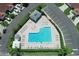 Aerial view of community pool with lounge chairs and ample parking at 2608 Edgewater Ct, Palmetto, FL 34221