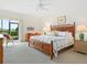 Spacious bedroom with king-size bed and access to a patio at 3240 Gulf Of Mexico Dr # B104, Longboat Key, FL 34228