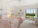 Guest bedroom with twin beds and sliding glass doors to patio at 3240 Gulf Of Mexico Dr # B104, Longboat Key, FL 34228