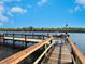 Wooden dock extending into the water at 3240 Gulf Of Mexico Dr # B104, Longboat Key, FL 34228