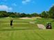 Golfer tees off on a beautiful course at 3240 Gulf Of Mexico Dr # B104, Longboat Key, FL 34228