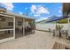 Screened patio with brick pavers, seating area, and grill at 330 Caruso Pl, Sarasota, FL 34237