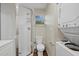 Clean bathroom with shower, toilet, and stackable washer/dryer at 330 Caruso Pl, Sarasota, FL 34237