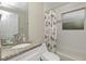 Clean bathroom with granite countertop, shower, and floral shower curtain at 330 Caruso Pl, Sarasota, FL 34237