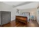 Bedroom with wood sleigh bed, dresser, and hardwood floors at 330 Caruso Pl, Sarasota, FL 34237