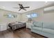 Comfortable bedroom with a bed, sofa, and ceiling fan at 330 Caruso Pl, Sarasota, FL 34237