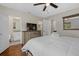 Bedroom with dresser, ensuite bathroom, and hardwood floors at 330 Caruso Pl, Sarasota, FL 34237