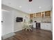 Well-equipped kitchenette with white cabinets and wine cooler at 330 Caruso Pl, Sarasota, FL 34237