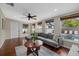 Living room features hardwood floors, sectional sofa, and pool view at 330 Caruso Pl, Sarasota, FL 34237