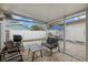 Relaxing screened patio with wicker furniture and a view of the backyard at 330 Caruso Pl, Sarasota, FL 34237