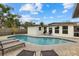 Spacious kidney-shaped pool with plenty of lounge chairs at 330 Caruso Pl, Sarasota, FL 34237