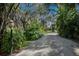 Long gravel driveway lined with tropical foliage at 3395 Hardee Dr, Venice, FL 34292