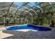 Enclosed kidney-shaped pool with brick patio at 3395 Hardee Dr, Venice, FL 34292