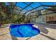 Inviting kidney-shaped pool with screened enclosure and brick paver patio at 3395 Hardee Dr, Venice, FL 34292