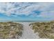 Sandy beach access path to ocean at 3491 Bayou Sound, Longboat Key, FL 34228