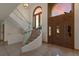 Light-filled entryway showcasing a curved staircase and a view to the backyard at 3491 Bayou Sound, Longboat Key, FL 34228