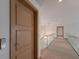 Elegant hallway with glass railing and modern light fixture at 3491 Bayou Sound, Longboat Key, FL 34228