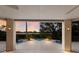 Serene view from covered patio, showcasing a lovely pool and tranquil sunset at 3491 Bayou Sound, Longboat Key, FL 34228