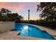 Inviting kidney-shaped pool reflecting the sunset at 3491 Bayou Sound, Longboat Key, FL 34228