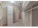 Bright walk-in closet with custom shelving and drawers at 3491 Bayou Sound, Longboat Key, FL 34228