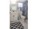 Clean bathroom, featuring a white vanity and patterned shower curtain at 3951 Lake Bayshore Dr # F408, Bradenton, FL 34205