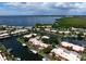 Aerial view of waterfront property with boat slips and lush landscaping at 4108 La Costa Cv, Bradenton, FL 34210