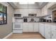 Well-equipped kitchen featuring white cabinets and modern appliances at 4108 La Costa Cv, Bradenton, FL 34210