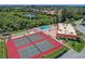 Community tennis courts and clubhouse with a pool in the background at 4108 La Costa Cv, Bradenton, FL 34210