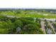 Aerial view of lush green golf course with water features and palm trees at 415 L Ambiance Dr # A401, Longboat Key, FL 34228