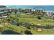 Aerial view showcasing a condo building near a golf course and ocean at 415 L Ambiance Dr # A401, Longboat Key, FL 34228