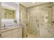 Bright bathroom with a walk-in shower and modern vanity at 415 L Ambiance Dr # A401, Longboat Key, FL 34228