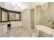 Elegant bathroom with marble flooring, double vanity, and a large soaking tub at 415 L Ambiance Dr # A401, Longboat Key, FL 34228