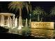 L'Ambiance entrance with a fountain and palm trees at night at 415 L Ambiance Dr # A401, Longboat Key, FL 34228