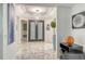 Elegant entryway with marble floors, modern art, and a statement piece at 415 L Ambiance Dr # A401, Longboat Key, FL 34228