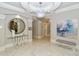 Elegant lobby with a large mirror, modern art, and marble floors at 415 L Ambiance Dr # A401, Longboat Key, FL 34228