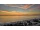 Breathtaking oceanfront view at sunset with sandy beach at 415 L Ambiance Dr # A401, Longboat Key, FL 34228