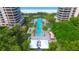 Resort-style pool with surrounding lounge chairs and lush landscaping at 415 L Ambiance Dr # A401, Longboat Key, FL 34228